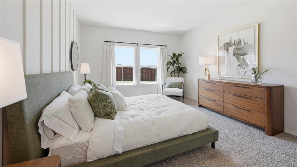 1957 Freeman Street Tyler, TX 75704 - Photo 16 of 25 Spacious bedroom featuring light gray carpeting, crisp white walls, a prominent accent wall with vertical paneling, and a large window with white curtain panels