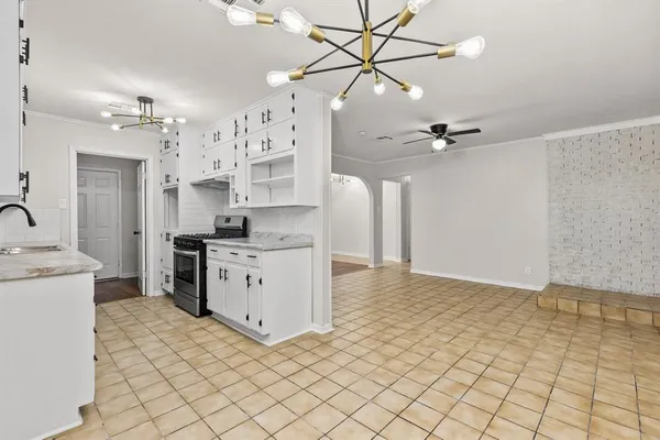 a kitchen with stainless steel appliances a stove a sink and a refrigerator
