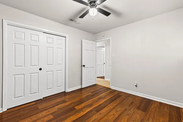 a view of room with hardwood floor and ceiling fan