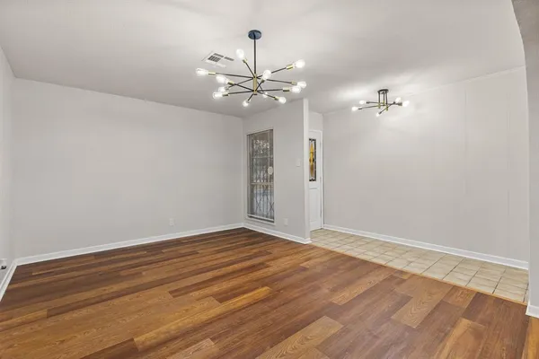 a view of a room with a ceiling fan hardwood floor and a ceiling fan