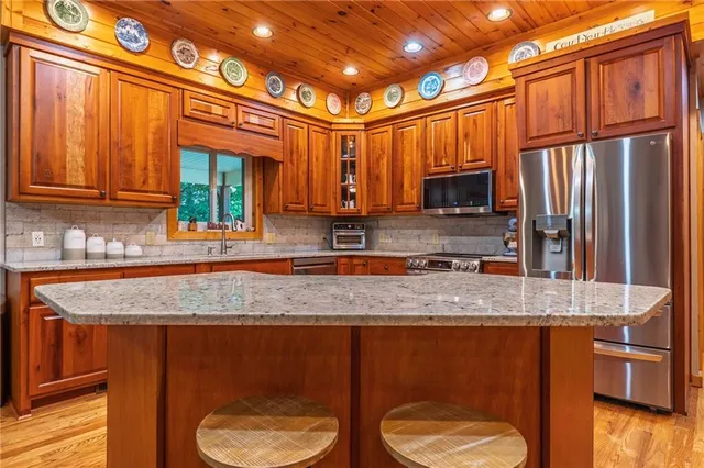 a kitchen with stainless steel appliances granite countertop a sink stove and cabinets
