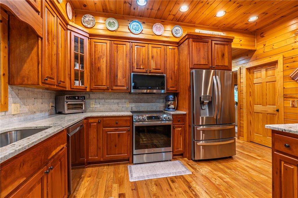 292 High Country Crossing Morganton, GA 30560 - Photo 12 of 35 a kitchen with stainless steel appliances granite countertop a stove a refrigerator and a microwave oven
