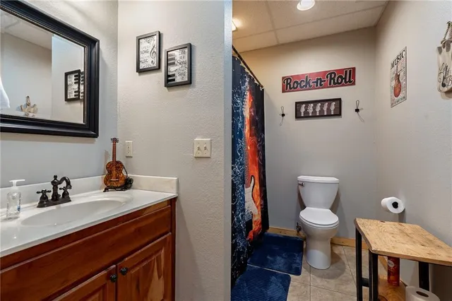 a bathroom with a toilet a sink and mirror