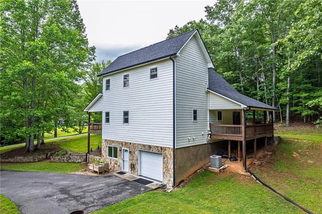 a view of a house with a yard and sitting area