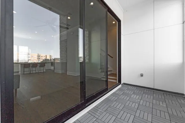 a bathroom with a glass shower door and a glass door