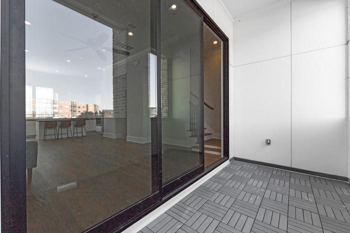 633 Dalton Lane Irving, TX 75039 - Photo 11 of 26 a bathroom with a glass shower door and a glass door
