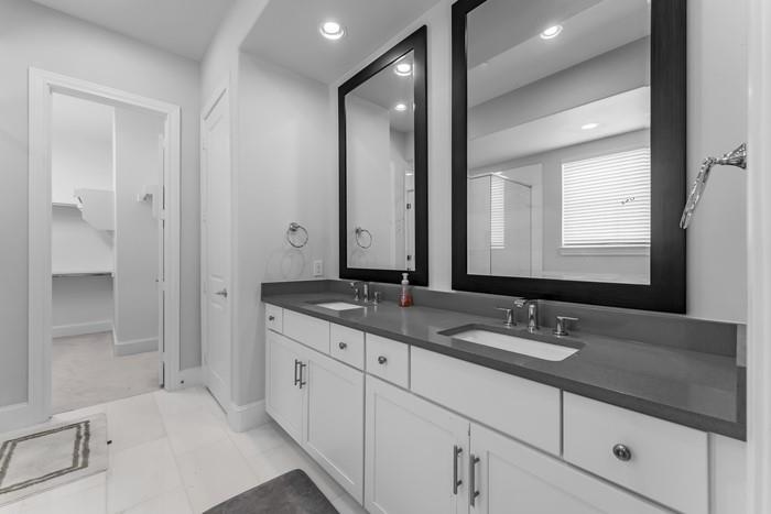 633 Dalton Lane Irving, TX 75039 - Photo 15 of 26 a bathroom with double sink and a mirror