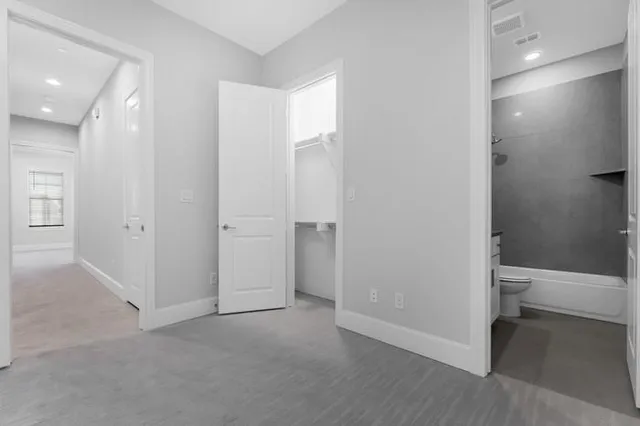 wooden floor and chair in a room with a bathroom