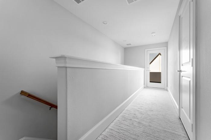 633 Dalton Lane Irving, TX 75039 - Photo 22 of 26 a view of a hallway with wooden floor and staircase