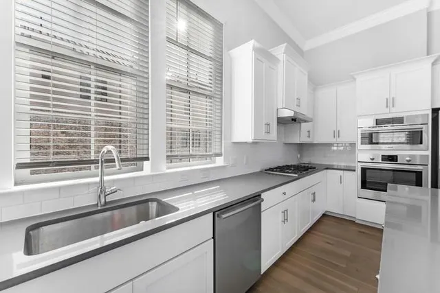 a kitchen that has a sink and a stove