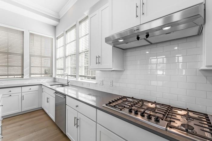 633 Dalton Lane Irving, TX 75039 - Photo 5 of 26 a kitchen with stainless steel appliances a sink a stove and cabinets