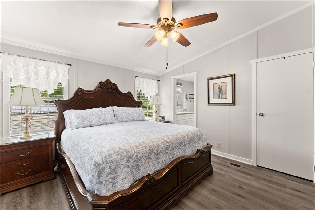 1689 Old State Road Pendergrass, GA 30567 - Photo 13 of 58 a bedroom with a bed and a chandelier