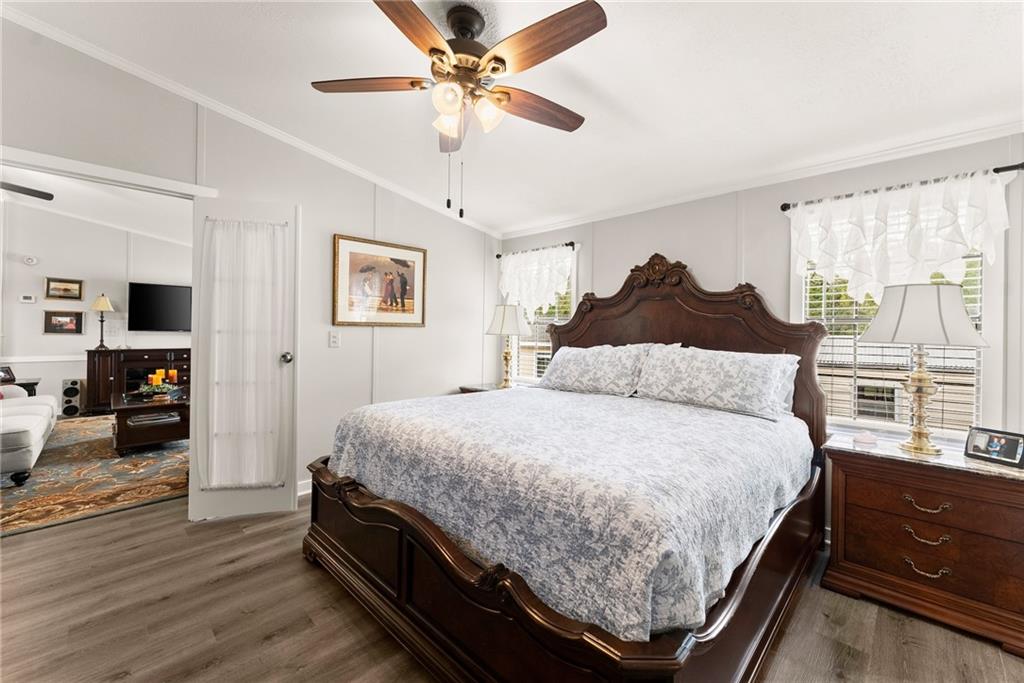 1689 Old State Road Pendergrass, GA 30567 - Photo 14 of 58 a large bedroom with a bed and wooden floor