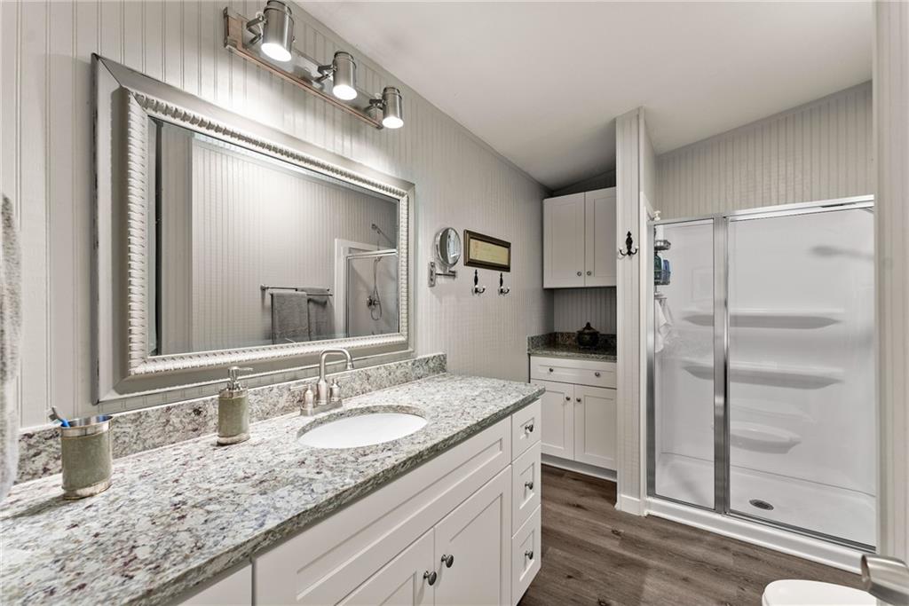 1689 Old State Road Pendergrass, GA 30567 - Photo 16 of 58 a bathroom with a granite countertop sink mirror and cabinets