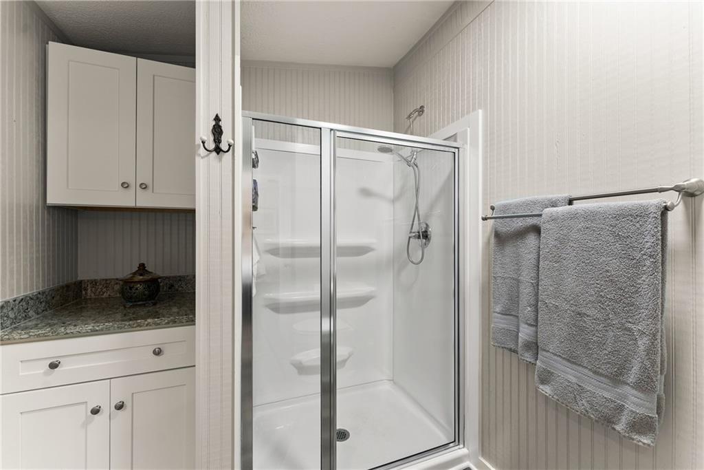 1689 Old State Road Pendergrass, GA 30567 - Photo 17 of 58 a bathroom with a granite countertop bathtub shower and vanity