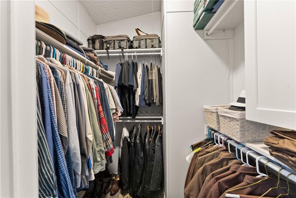 1689 Old State Road Pendergrass, GA 30567 - Photo 18 of 58 a view of walk in closet with clothes and shoes