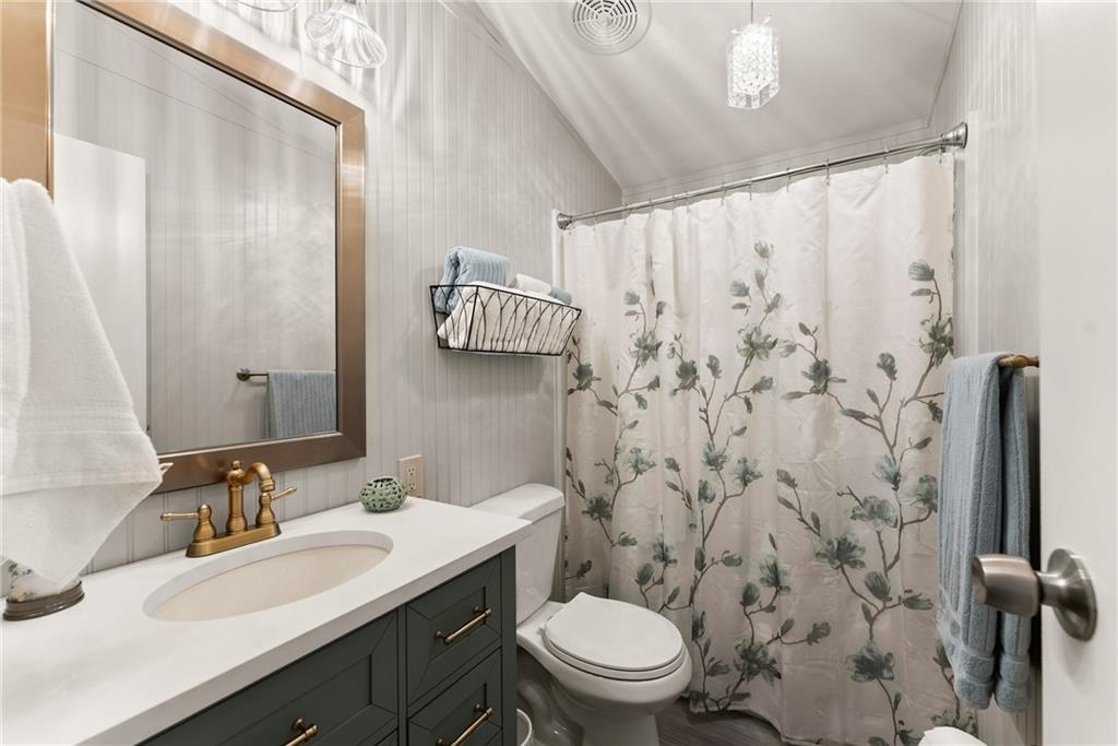 1689 Old State Road Pendergrass, GA 30567 - Photo 21 of 58 a bathroom with a granite countertop toilet sink mirror and shower