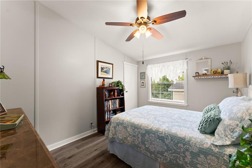 1689 Old State Road Pendergrass, GA 30567 - Photo 22 of 58 a bedroom with a large bed chandelier and a window