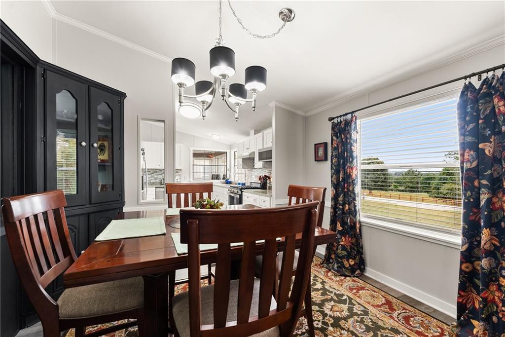 1689 Old State Road Pendergrass, GA 30567 - Photo 24 of 58 a view of a dining room with furniture window and wooden floor