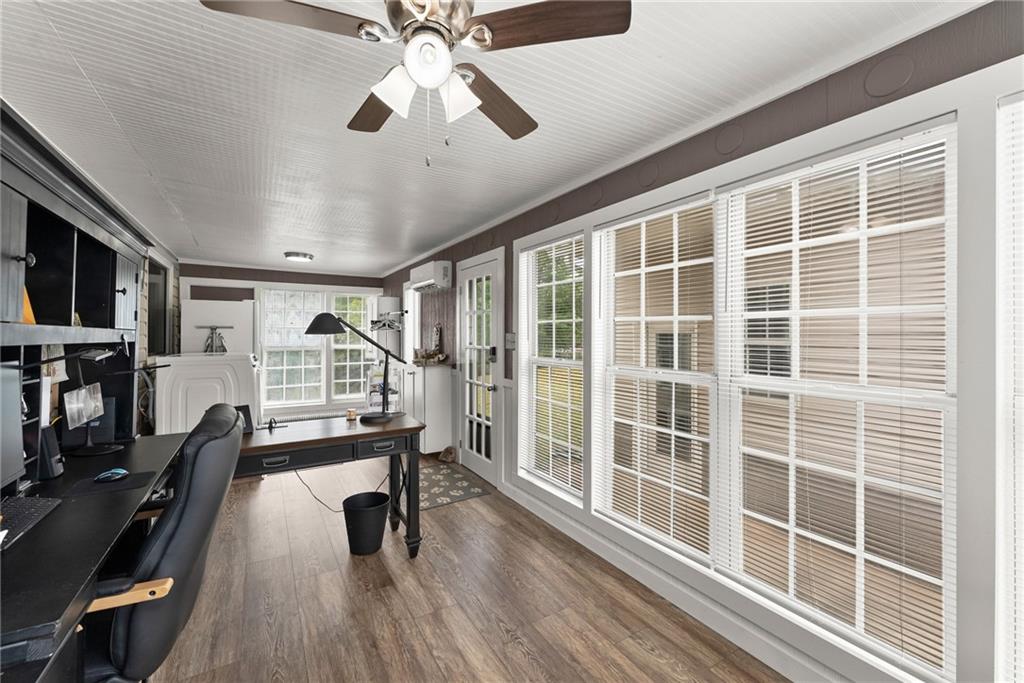 1689 Old State Road Pendergrass, GA 30567 - Photo 36 of 58 a view of a livingroom with furniture wooden floor and a ceiling fan