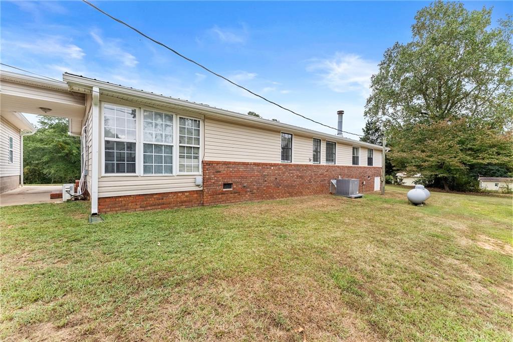 1689 Old State Road Pendergrass, GA 30567 - Photo 37 of 58 a front view of a house with garden