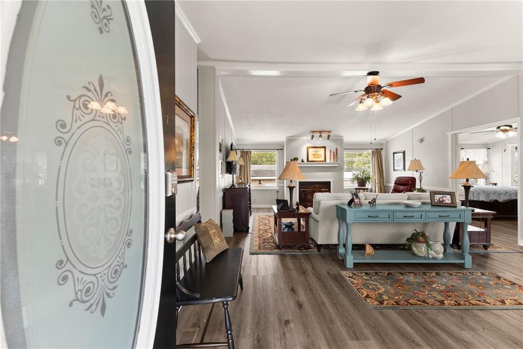 1689 Old State Road Pendergrass, GA 30567 - Photo 8 of 58 a living room with furniture a dining table and a chandelier