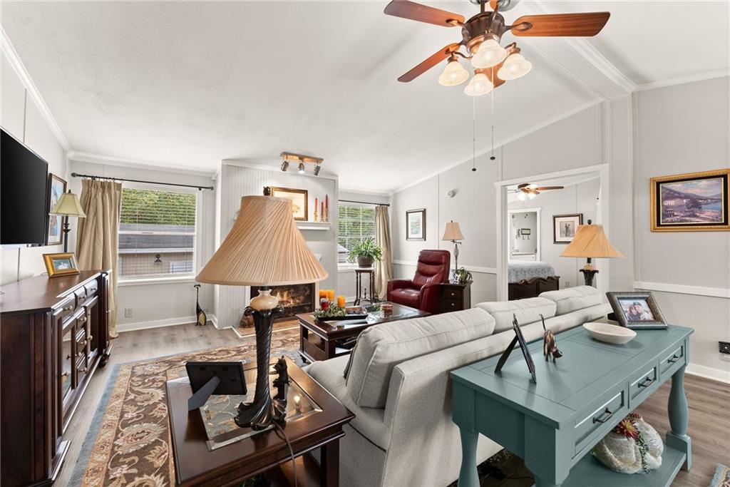 1689 Old State Road Pendergrass, GA 30567 - Photo 9 of 58 a living room with furniture a flat screen tv and a table