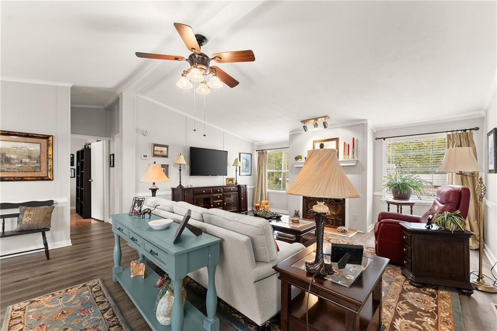 1689 Old State Road Pendergrass, GA 30567 - Photo 10 of 58 a living room with furniture a flat screen tv and a large window