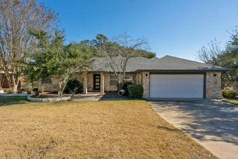 a view of a house with a yard and tree
