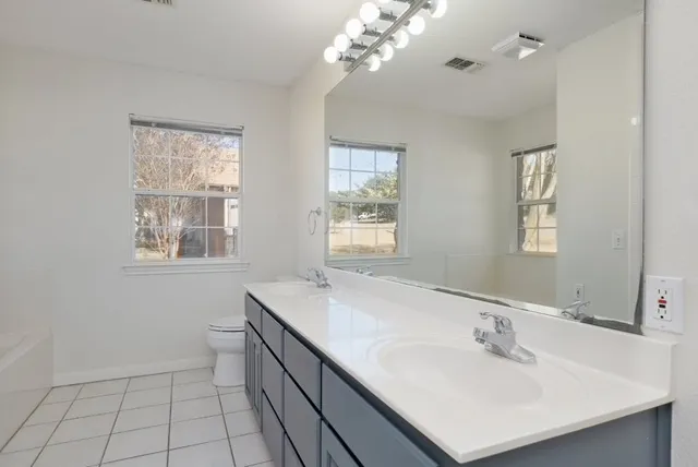 a bathroom with a sink a mirror and a window