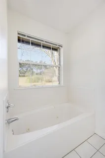 a bath tub sitting next to a window