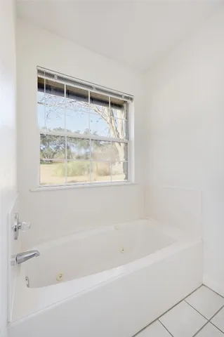 a bath tub sitting next to a window