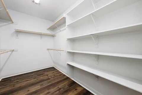 a view of walk in closet with empty racks