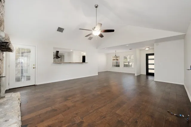 a view of an empty room with window and cabinet