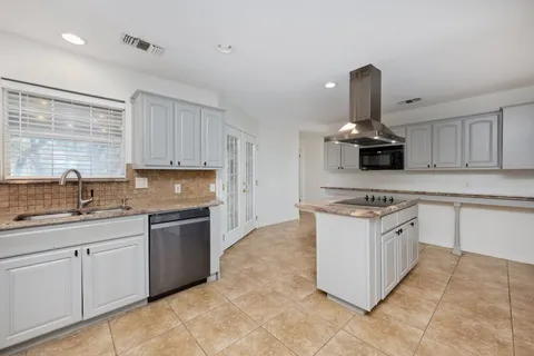 a kitchen with a sink stove and cabinets