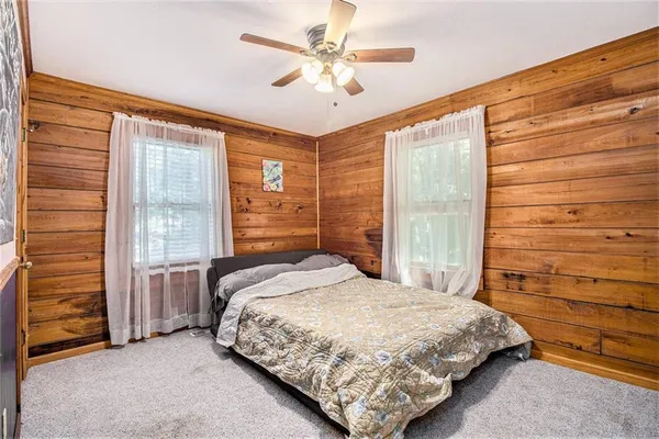 a bedroom with a bed dresser and a window
