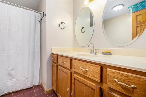 a bathroom with a mirror sink and vanity