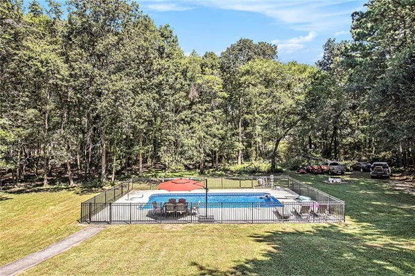 a view of a swimming pool with an outdoor seating and yard