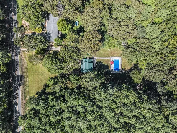 a view of a house with a yard and a tree