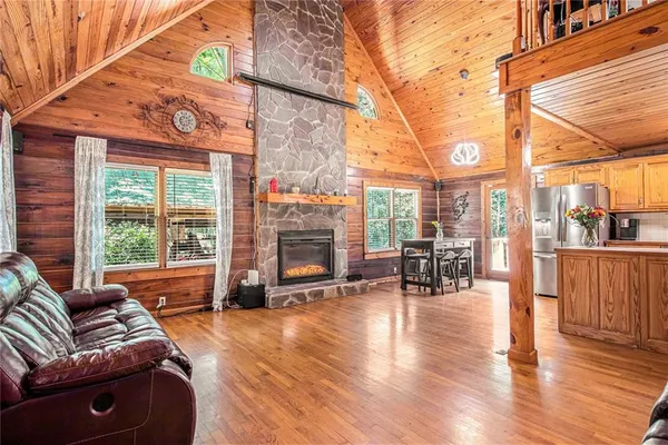 a living room with furniture and a floor to ceiling window