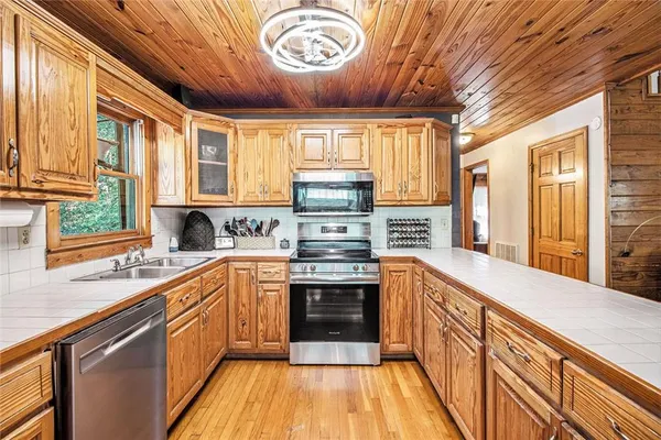 a kitchen with stainless steel appliances granite countertop a stove and a sink