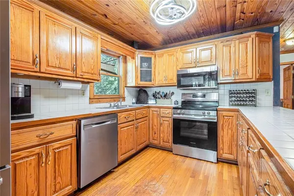 a kitchen with stainless steel appliances granite countertop a stove and a sink