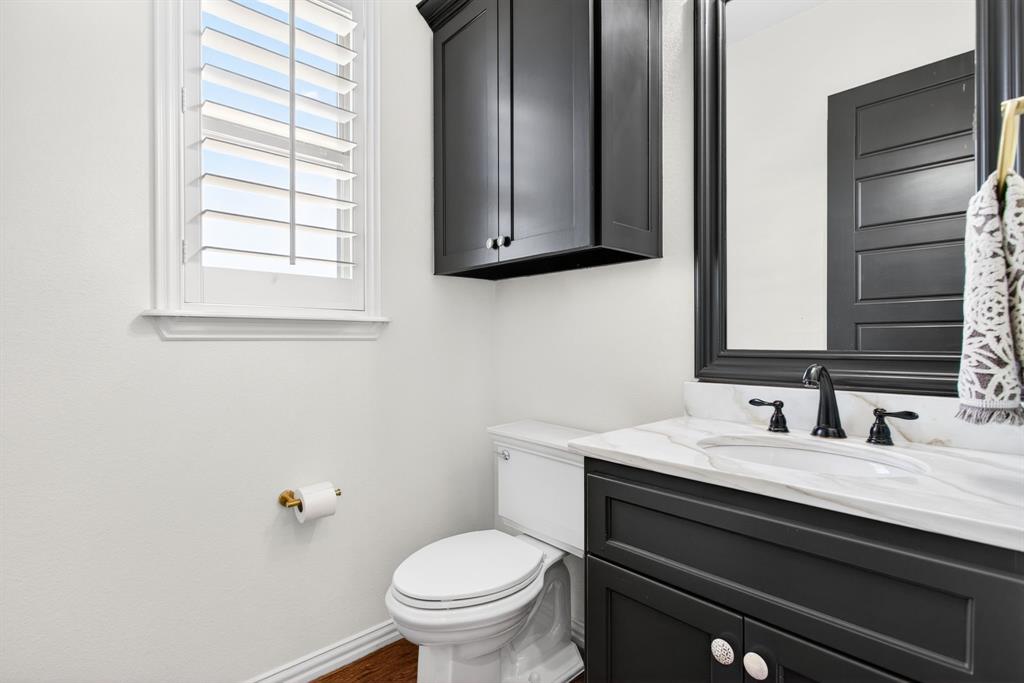 301 Rustic View Lane Aledo, TX 76008 - Photo 17 of 40 a bathroom with a toilet sink and mirror