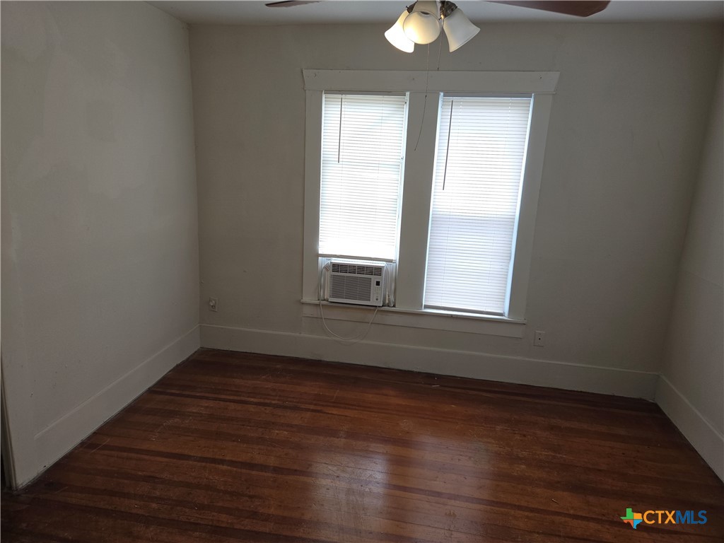 1219 South 10th Street Temple, TX 76504 - Photo 7 of 7 a view of an empty room with wooden floor and a window
