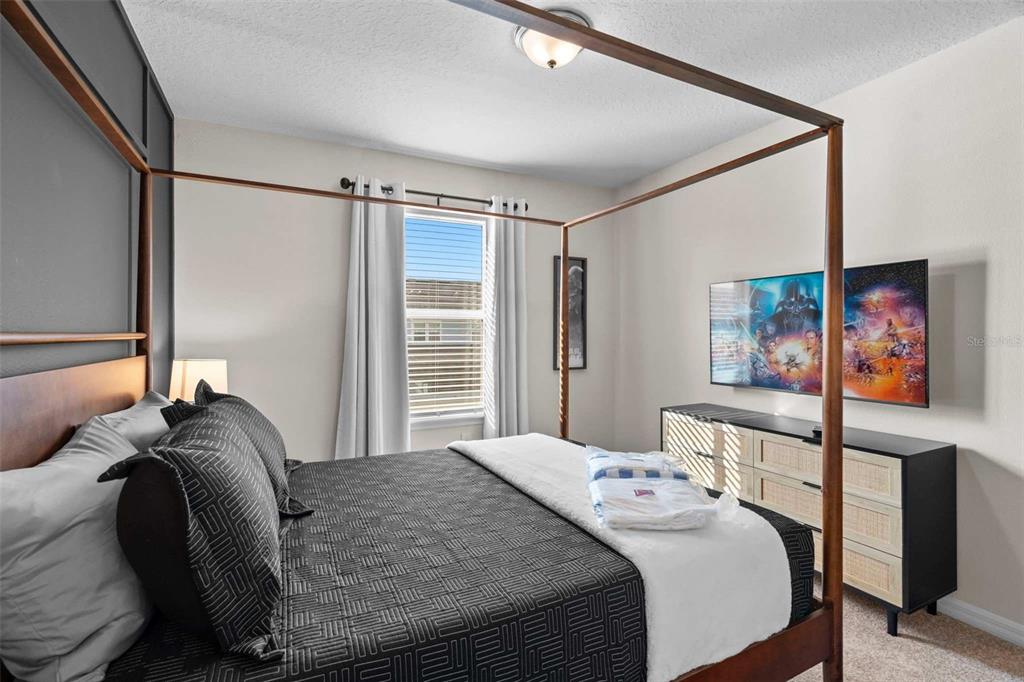 1283 Blue Paradise Way Clermont, FL 34714 - Photo 17 of 55 a bedroom with a bed and wooden floor