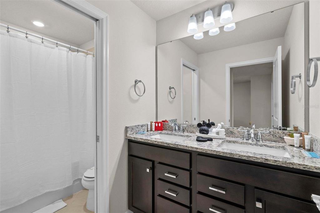 1283 Blue Paradise Way Clermont, FL 34714 - Photo 36 of 55 a bathroom with a double vanity sink and a mirror