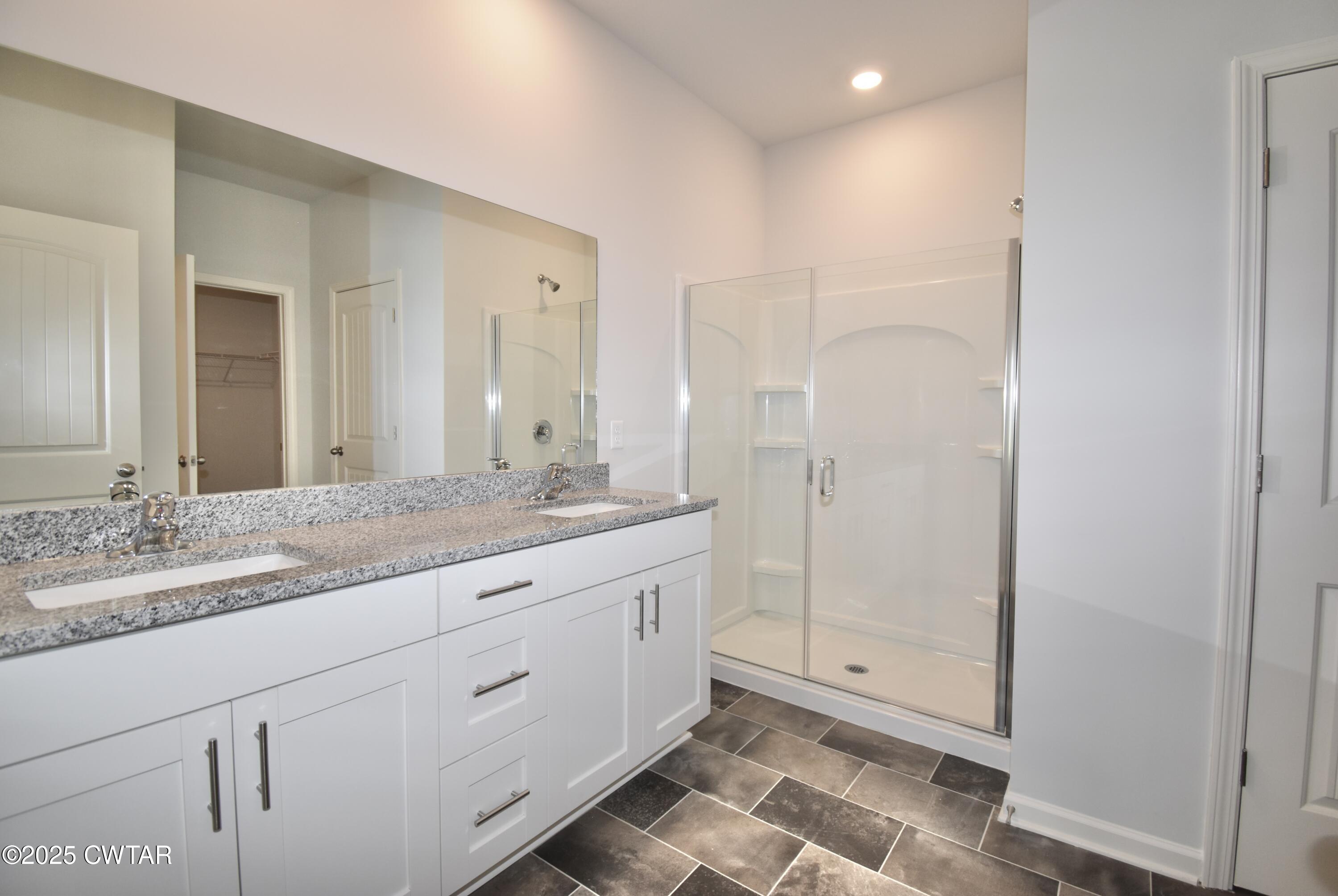 75 Clarendon Cove Jackson, TN 38305 - Photo 13 of 21 a bathroom with a granite countertop sink two mirror and shower