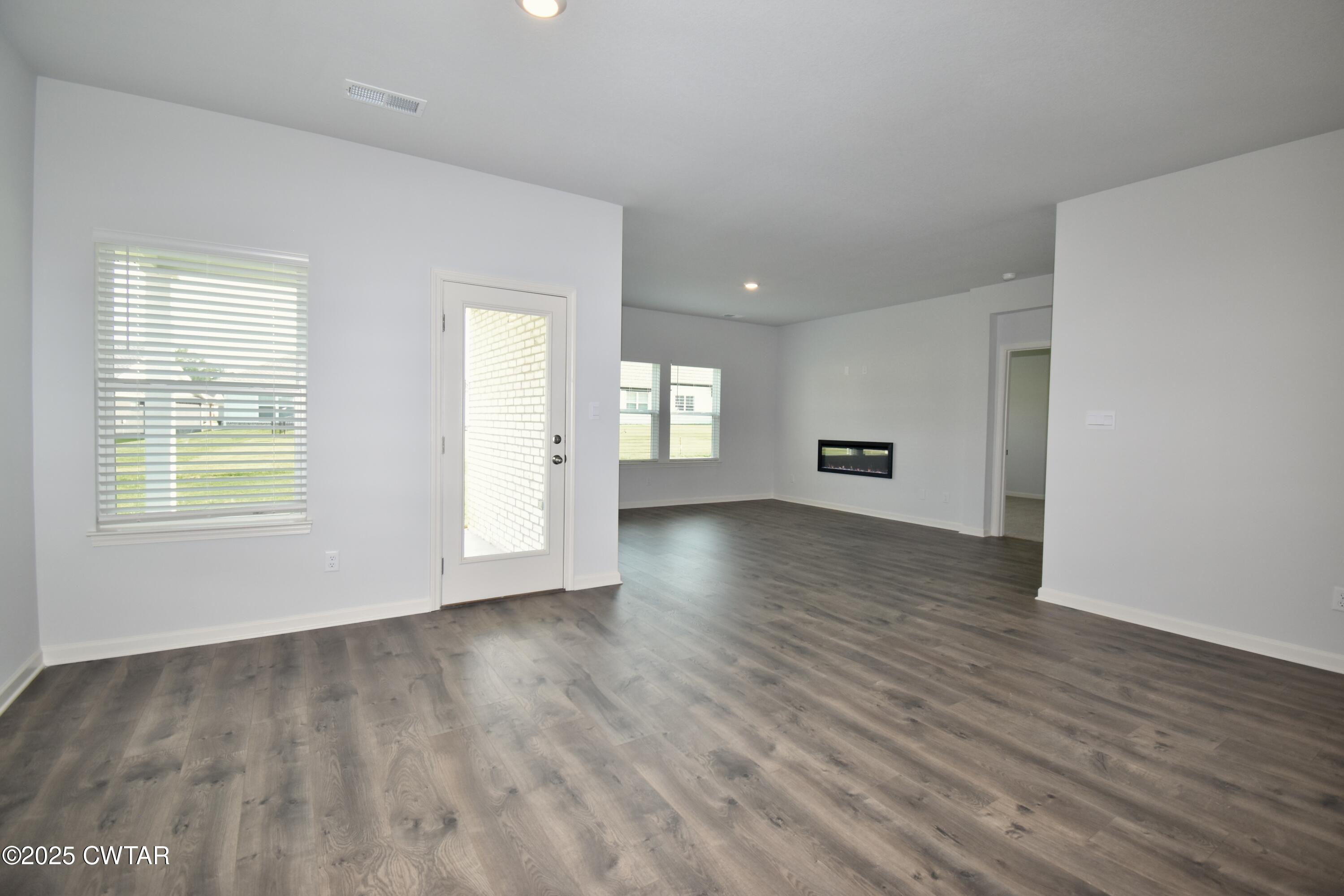 75 Clarendon Cove Jackson, TN 38305 - Photo 6 of 21 an empty room with wooden floor and windows