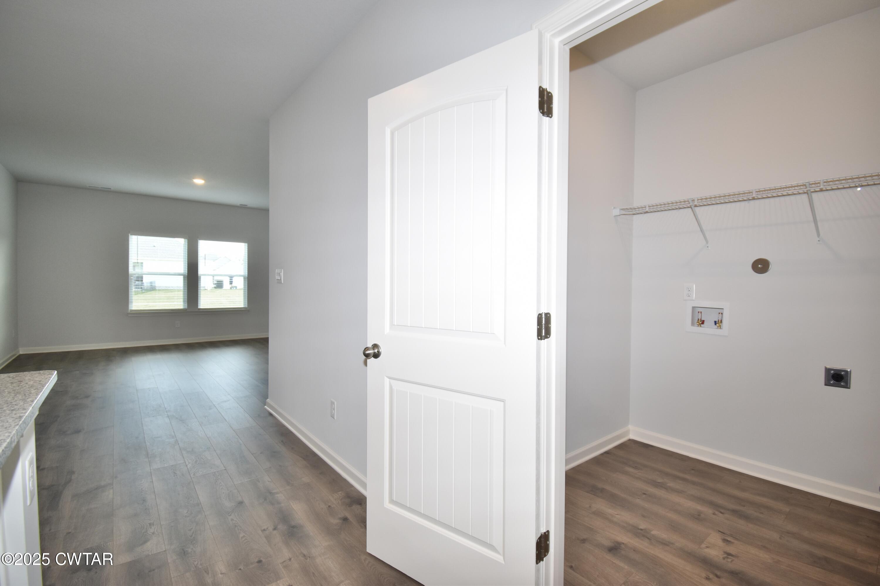 75 Clarendon Cove Jackson, TN 38305 - Photo 10 of 21 an empty room with wooden floor and windows