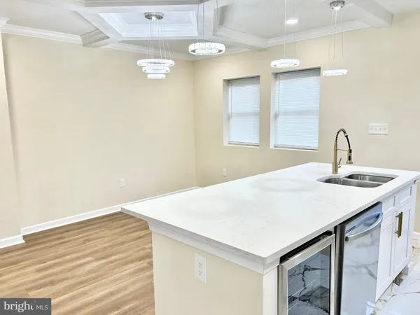 a kitchen with a sink cabinets and wooden floor
